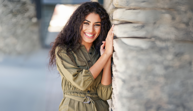 Woman smiling outdoors representing modern halal matchmaking and cultural compatibility in edison