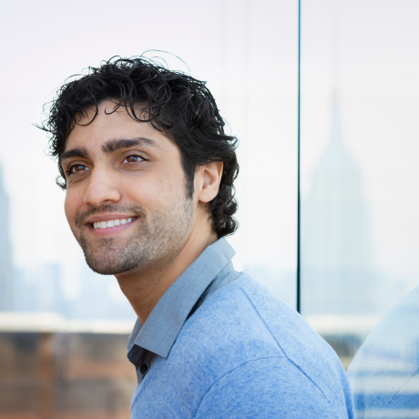 Confident Muslim man smiling outdoors, ideal profile for Muslim matrimonial services in north-bergen