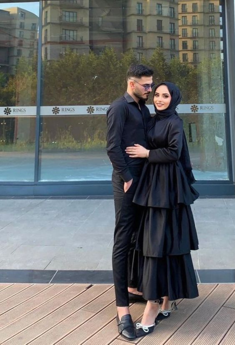 Stylish Muslim couple embracing outdoors